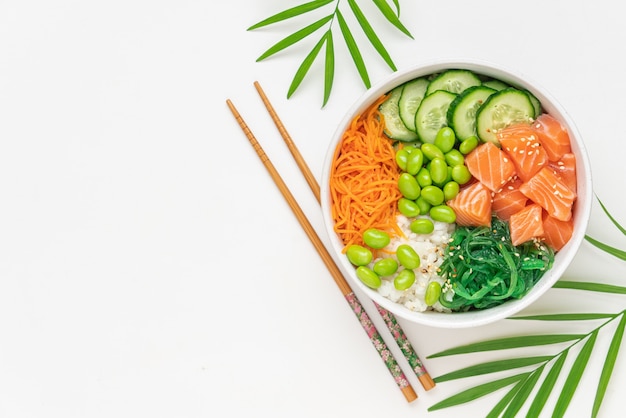 Poke tigela com salmão fresco salada chukka feijão edamame cenoura e pepino Tigela de comida saudável em fundo branco