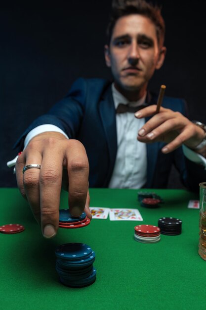 Pokerspieler mit Karten und Chips am grünen Tisch im Casino.