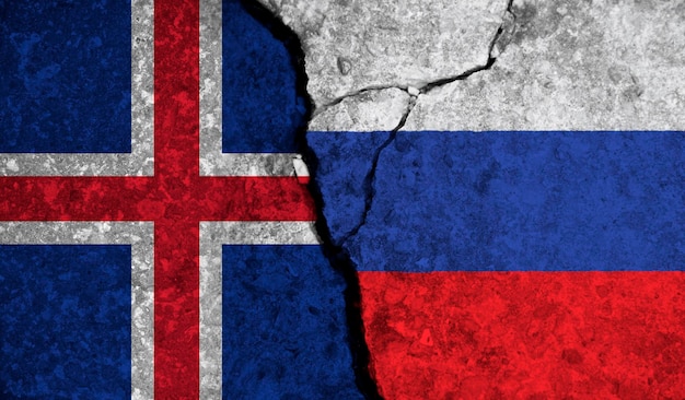 Politische Beziehung zwischen isländischen und russischen Nationalflaggen auf gerissenem Betonhintergrund