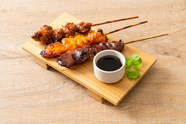 Pollo a la parrilla japonés o yakitori servido al estilo izakaya