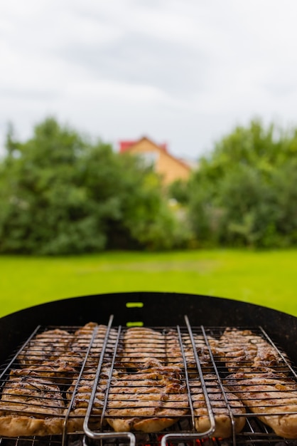 Foto pollo a la parrilla marinado a la parrilla en llamas