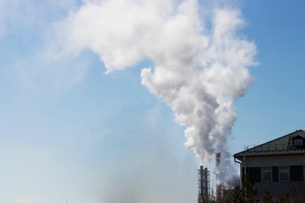 Foto poluição atmosférica branca do tubo de fábrica no céu