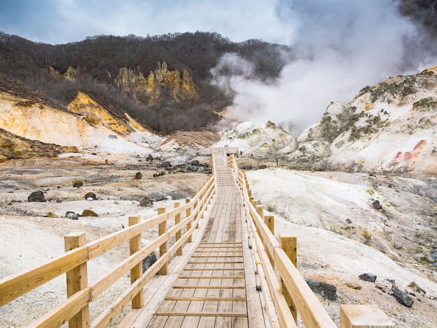 Foto ponte de pedestres que leva para a fumaça na montanha