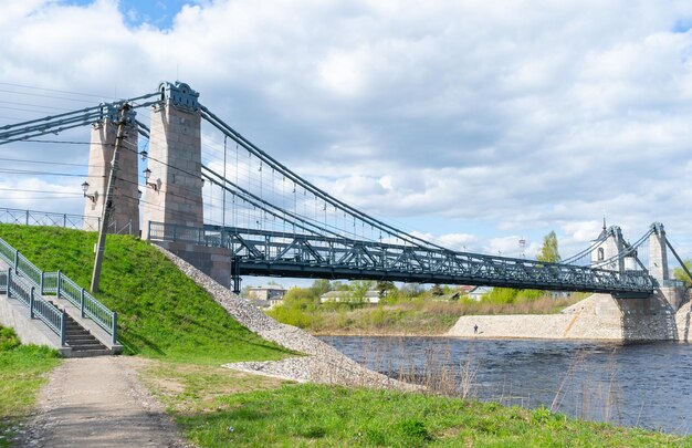 Foto pontes de cadeia únicos sobre a ponte suspensa do rio velikaya sobre o rio velikaya na cidade