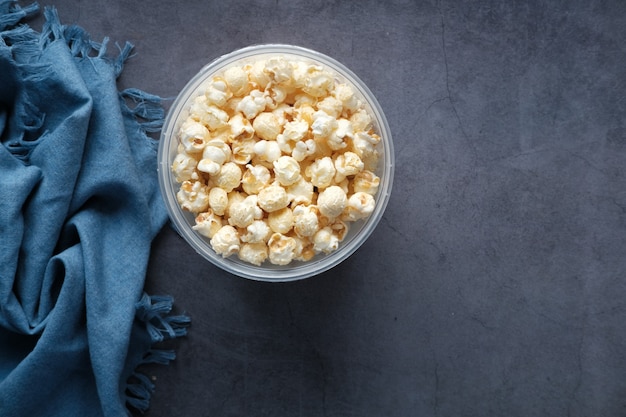 Popcorn in einer Schüssel auf Holzschreibtisch