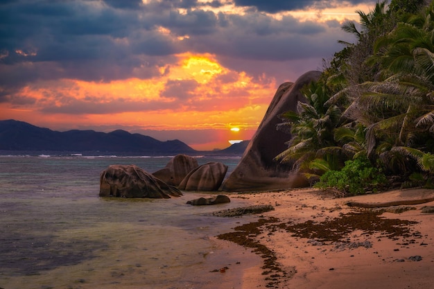 Pôr do sol colorido sobre a praia anse source dargent na ilha seychelles de la digue
