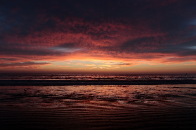 Foto pôr do sol laranja com nuvens no fundo do oceano pacífico verão lindas águas