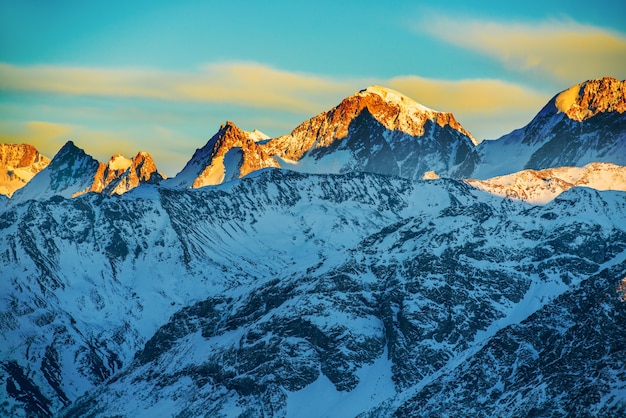 Pôr do sol nas montanhas cobertas de neve.