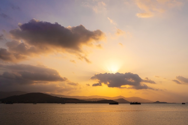 Pôr do sol sobre a baía com barcos de pesca.