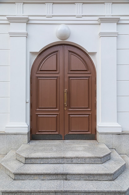 Foto porta arqueada de madeira com escada de granito