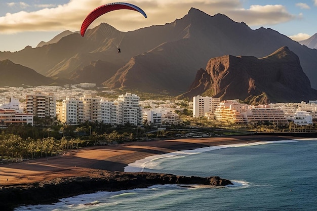 Porta de la Cruz, Tenerife, Espanha. O parapente está a aterrar na costa do Atlântico.