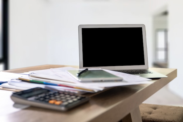 Portátil con pantalla en blanco sobre la mesa. Nuevo proyecto de fondo de espacio de trabajo en computadora portátil con pantalla de espacio de copia en blanco para su mensaje de texto publicitario