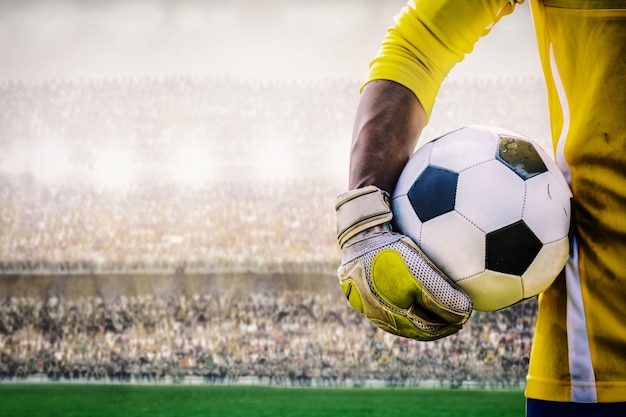 portero con un balón de fútbol en el estadio