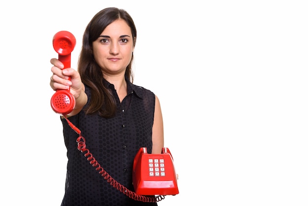 Porträt der jungen schönen Frau unter Verwendung des alten Telefons