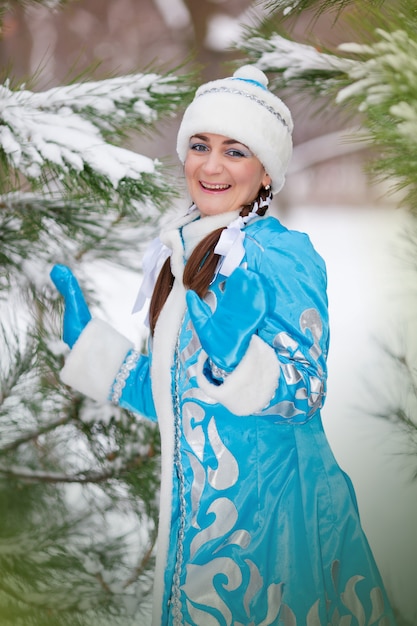 Porträt des Mädchens in einer Kappe im Winter im Holz