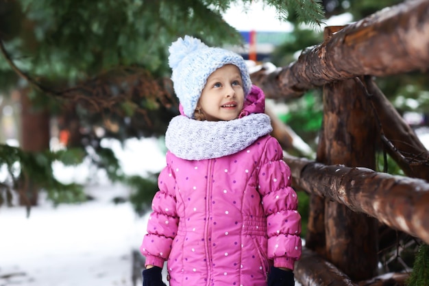 Porträt des netten kleinen Mädchens im Winterpark