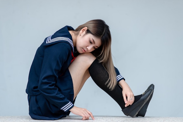 Porträt einer asiatischen Frau, die ein Studentenkleid im japanischen Stil trägt