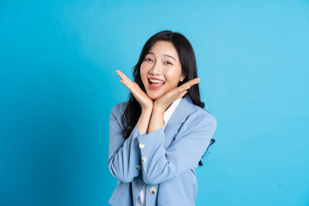 Porträt einer asiatischen Geschäftsfrau, die auf blauem Hintergrund posiert