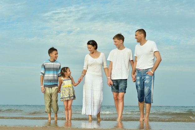 Porträt einer glücklichen Familie am Strand im Sommer