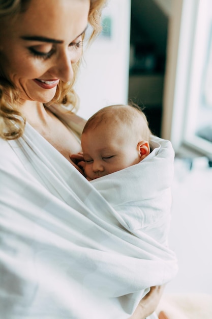 Porträt einer glücklichen Mutter, die ihr Baby zu Hause hält
