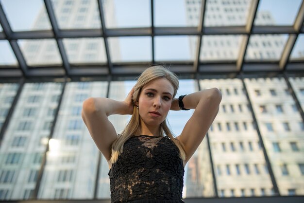 Foto porträt einer jungen frau, die gegen ein fenster steht