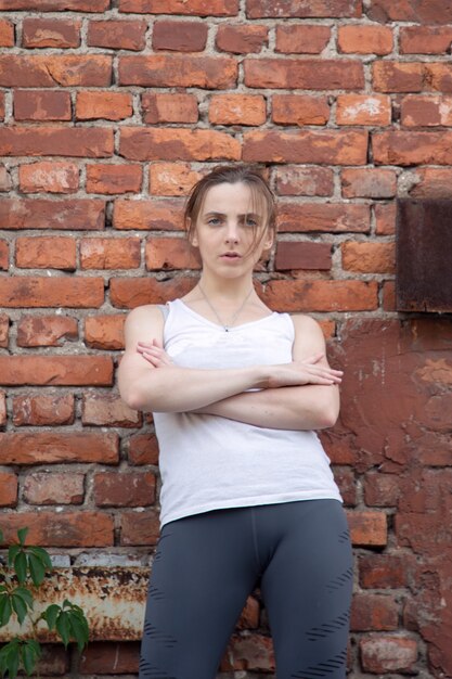 Porträt einer jungen Sportlerin vor dem Hintergrund einer roten Wand