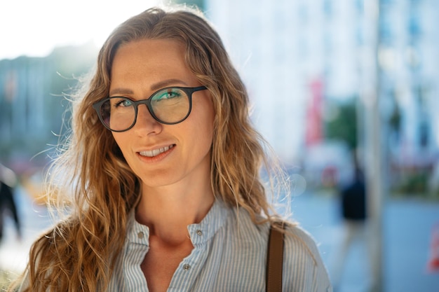 Porträt einer kaukasischen Geschäftsfrau mit Brille auf der Stadtstraße