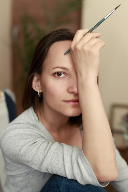 Porträt einer künstlerin mit einer quastennahaufnahme