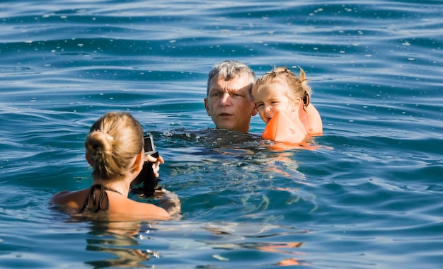 Porträt einer Mutter und eines Mädchens, die im Wasser schwimmen