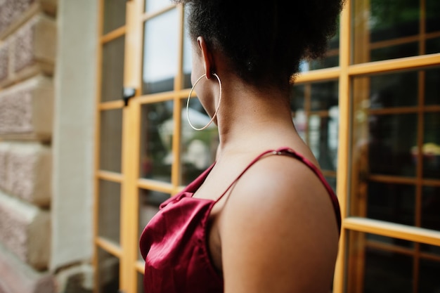 Porträt einer schönen natürlichen jungen Afrikanerin mit Afro-Haar Schwarzes Modell in rotem Seidenkleid