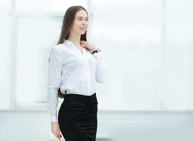 Porträt einer selbstbewussten Geschäftsfrau auf dem Hintergrund eines geräumigen Büros