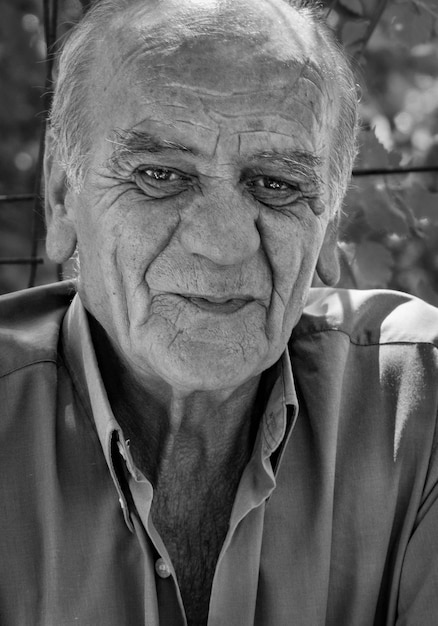 Porträt eines ernsthaften alten griechischen Mannes im Ruhestand mit einem Lächeln in schwarz-weißer Farbe in Griechenland