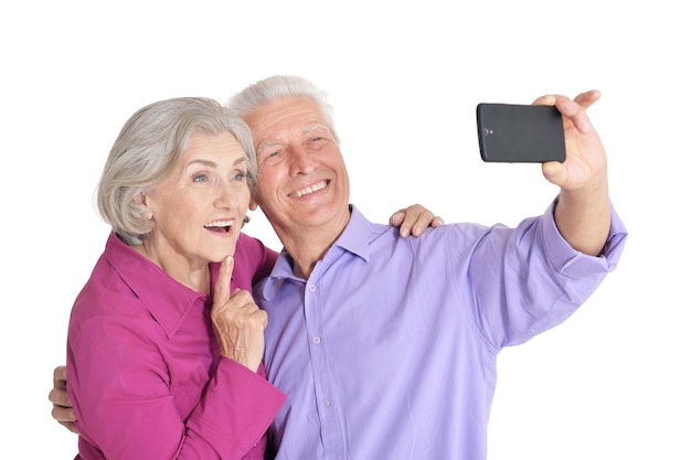 Porträt eines glücklichen älteren Paares, das selfie Foto auf weißem Hintergrund macht
