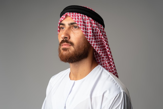 Porträt eines jungen arabischen Mannes auf grauem Hintergrund im Studio