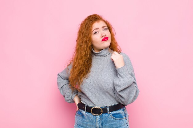 Porträt eines jungen Mädchens gegen eine rosa Wand