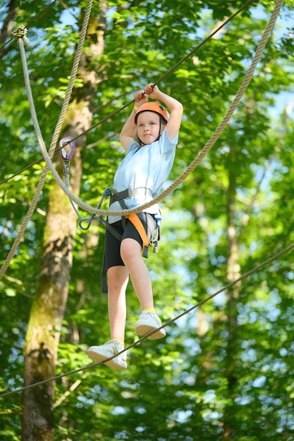 Porträt eines kleinen Mädchens, das sich im Outdoor-Extrem-Abenteuerseilpark vergnügt. Aktive Kinder in der Natur