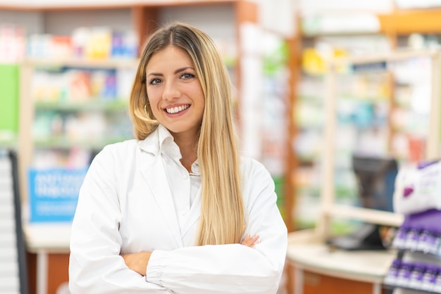 Foto porträt eines lächelnden jungen apothekers in einer apotheke