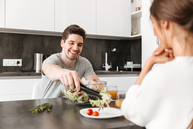 Porträt eines lächelnden jungen Mannes, der gesundes Frühstück hat