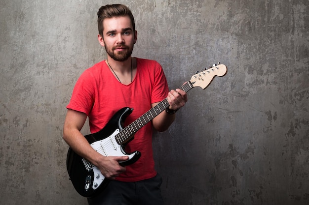 Foto porträt eines mannes, der gitarre spielt