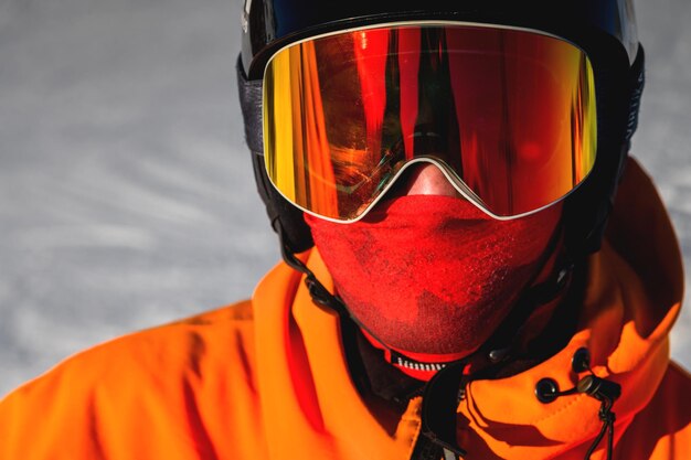 Porträt eines Mannes mit gelben Augen Foto eines jungen ernsthaften Sportlers in Helm und Skibrille