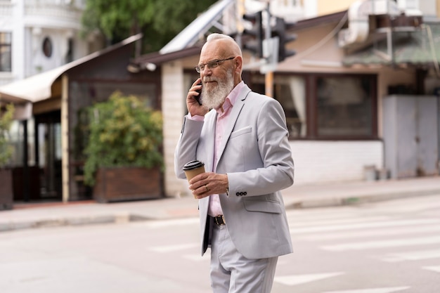 Porträt eines stilvollen älteren Mannes, der am Telefon spricht