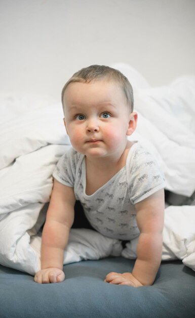 Foto porträt eines süßen babys, das zu hause auf dem bett liegt