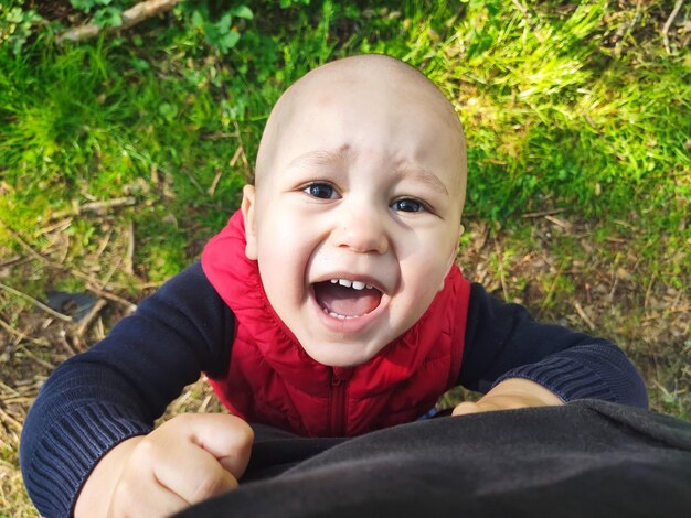 Foto porträt eines süßen jungen, der im park schreit