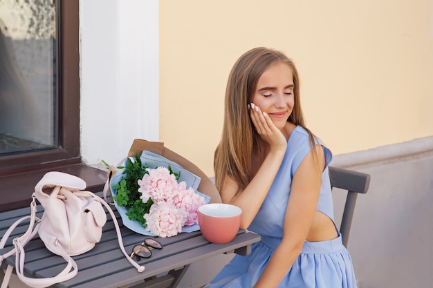 Porträt von den modischen Frauen der modernen Mode, die Restaurant im im Freien mit Tasse Kaffee sitzen