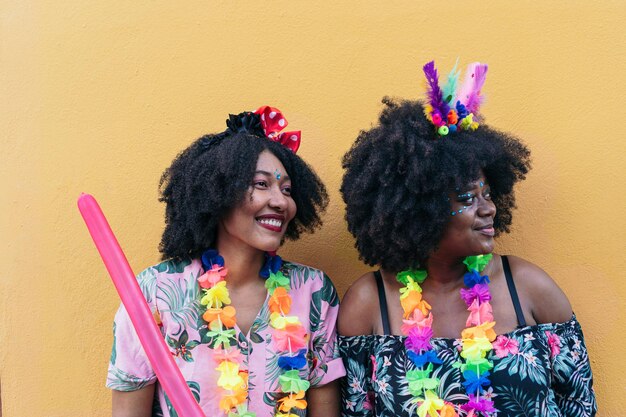 Porträt von zwei Afro-Frauen, die Straßenkarneval feiern