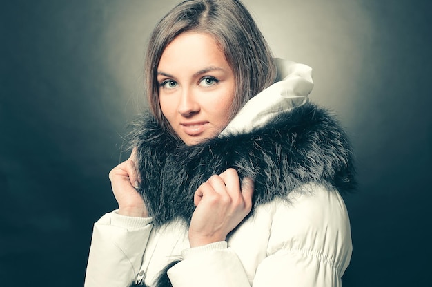 Portrait der schönen jungen Frau in der Winterjacke