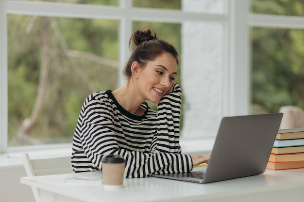 Portrait junges Mädchen mit Laptop-Computer im Büro Studentin, die zu Hause arbeitet Arbeiten oder studieren Sie von zu Hause aus freiberufliches Business-Lifestyle-Konzept