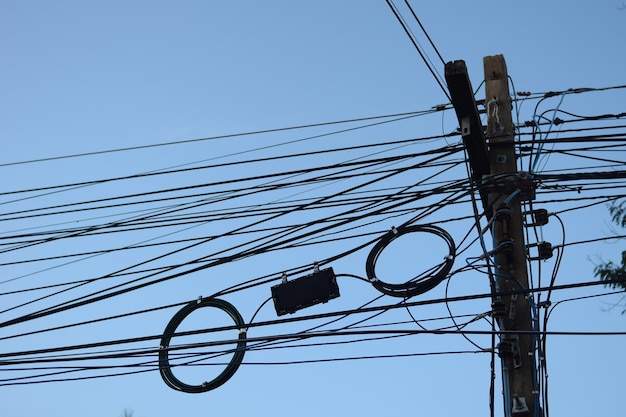 Poste eléctrico con línea eléctrica en el cielo azul en estilo tailandés