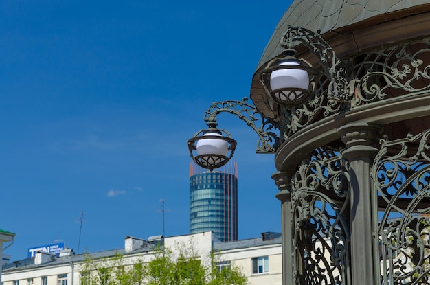 Un poste de luz con un edificio al fondo.