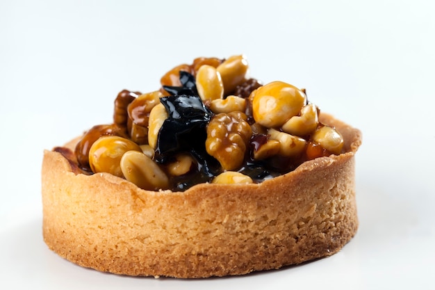 Postre de masa, tartaletas con relleno de avellanas, cacahuetes y nueces y frutos secos de ciruelas y albaricoques, tartaletas de nueces cubiertas con una capa de caramelo de azúcar